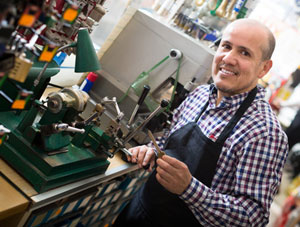 Mature man making duplicates of keys locksmith